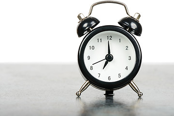 Image showing Black alarm clock on the table