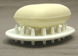 Image showing Beige soap on a soap dish on a gray background