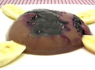 Image showing Chocolate pudding with blueberries, banana and pieces of almonds