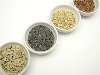 Image showing Four bowl with different seeds on a white background