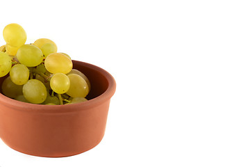 Image showing Green grapes in wooden plate on white background