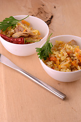 Image showing Chinese cuisine - fried rice with meat on wooden background