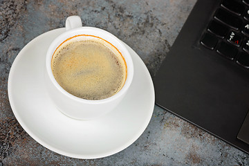 Image showing Shot of cup of coffee and kayboard