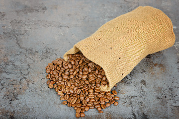 Image showing Coffee beans spilled out of the bag