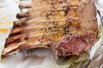 Image showing Roast rack of lamb on tinfoil