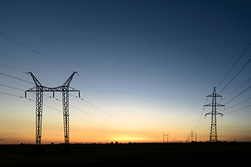 Image showing Large transmission towers at sunset