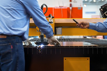 Image showing Machine cutting steel in a factory