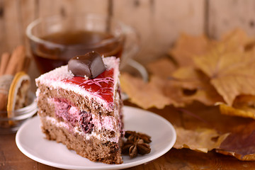 Image showing cup of hot tea, sweete cake and autumn leaves