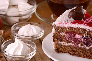 Image showing Chocolate Cake with tea cup and meringues