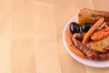 Image showing Grilled sausage with fresh salad on wooden background