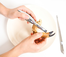 Image showing Female person eating crab claw over plate