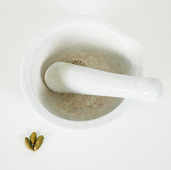 Image showing White marble mortar with whole cardamom on the side