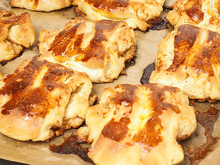 Image showing Fresh made cinnamon buns plaited on baking paper