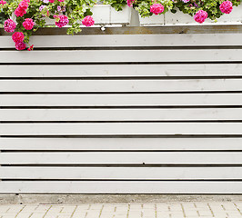 Image showing gray horizontal plank fence with flowerpots