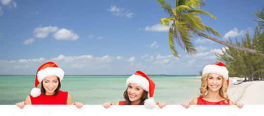 Image showing women in santa helper hat with blank white board