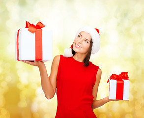 Image showing smiling woman in red dress with gift box