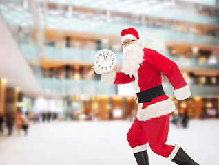 Image showing man in costume of santa claus with clock