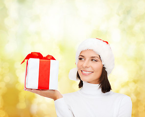 Image showing smiling woman in santa helper hat with gift box