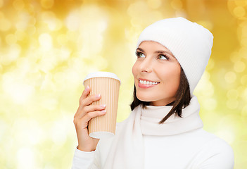 Image showing smiling young woman in winter clothes with cup