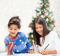 Image showing mother and daughter with coloring pencils indoors