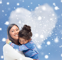 Image showing smiling little girl and mother hugging indoors