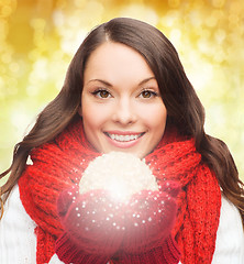Image showing smiling woman in winter clothes with snowball