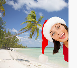 Image showing woman in santa helper hat with blank white board