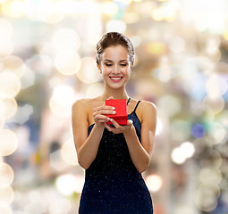 Image showing smiling woman holding red gift box