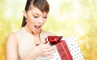 Image showing smiling woman in red dress with gift box