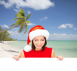 Image showing woman in santa helper hat with blank white board