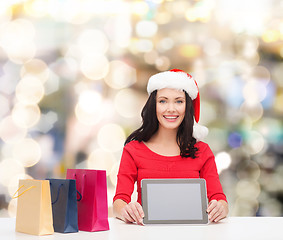 Image showing smiling woman with shopping bags and tablet pc