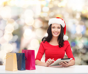 Image showing smiling woman with shopping bags and tablet pc