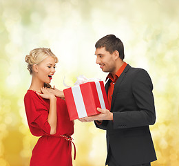 Image showing smiling man and woman with present