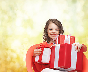 Image showing smiling little girl with gift boxes