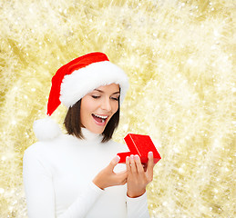 Image showing smiling woman in santa helper hat with gift box