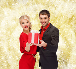 Image showing smiling man and woman with present