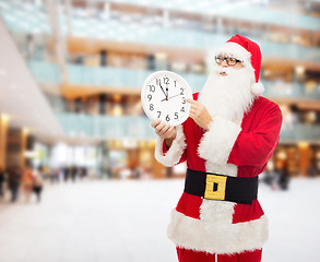 Image showing man in costume of santa claus with clock