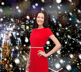 Image showing smiling woman in red dress