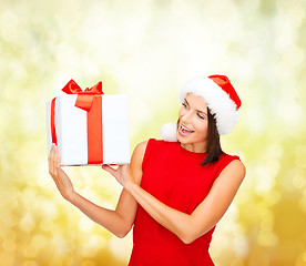 Image showing smiling woman in red dress with gift box