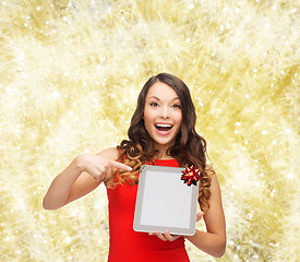 Image showing smiling woman in red dress with tablet pc