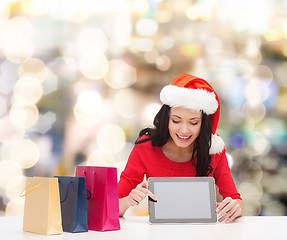 Image showing smiling woman with shopping bags and tablet pc