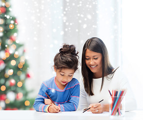 Image showing mother and daughter with coloring pencils indoors