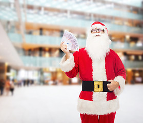 Image showing man in costume of santa claus with euro money