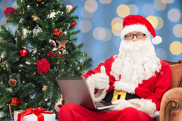 Image showing man in costume of santa claus with laptop