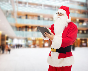 Image showing man in costume of santa claus with tablet pc