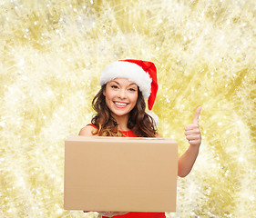 Image showing smiling woman in santa helper hat with parcel box