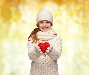 Image showing dreaming girl in winter clothes with red heart