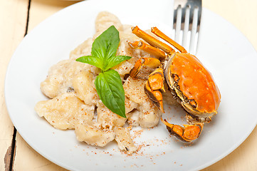 Image showing Italian gnocchi with seafood sauce with crab and basil