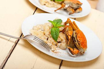 Image showing Italian gnocchi with seafood sauce with crab and basil