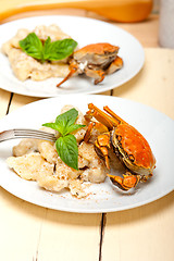 Image showing Italian gnocchi with seafood sauce with crab and basil